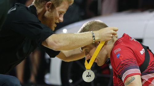 Harry awards the silver medal to Omrod. (Getty)