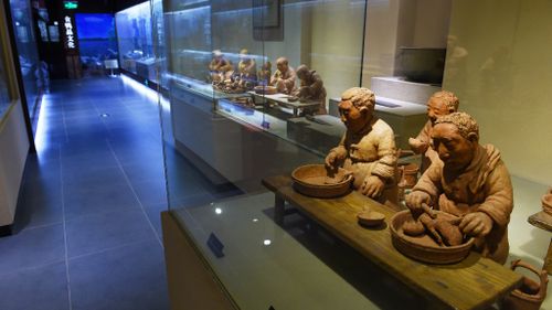 Clay figures showing the preparation of Peking duck in the Beijing museum. (Getty)