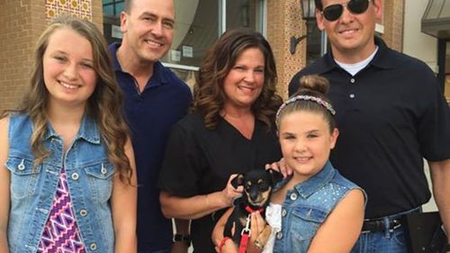 Puppy love: US police officer surprises family with dog rescued from hot car