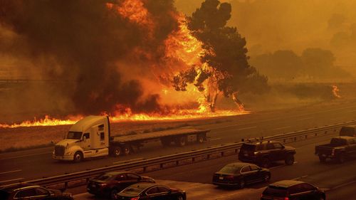 Flames from the LNU Lightning Complex fires jump Interstate 80 in Vacaville, California. California Wildfires