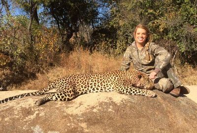The alleged conservationist, beams again with a leopard.