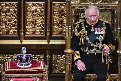 Prince Charles, Prince of Wales (R) sits by the The Imperial State Crown (L) in the House of Lords Chamber, during the State Opening of Parliament, in the Houses of Parliament, in London, on May 10, 2022
