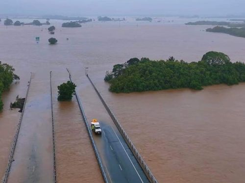Record-level floods swallow major roads in far north Queensland
