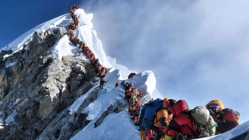 A long line of mountaineers lines up on a path on Mount Everest, in this photo that made headlines around the world.