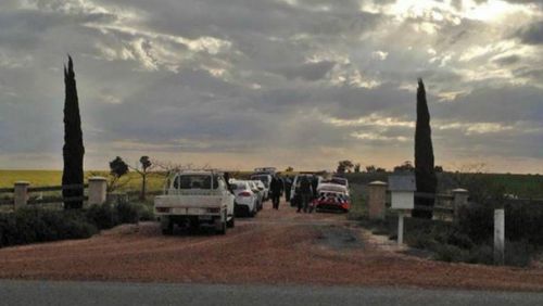 Police at the entry to the property in the NSW Riverina district where a woman and three children have been shot dead. (Andrew Pearson/The Daily Advertiser)