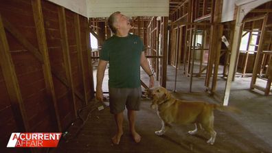 Retiree Glen Lewis inside his flood-wrecked home.