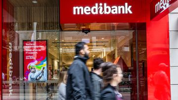 People walk past a Medibank outlet in Sydney.