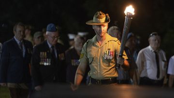 At the Darwin Cenotaph a the Anzac Dawn Service was commenced with the lighting of a torch. A Cenotaph is an empty tomb or a monument built in honour of a person or group of people whose remains are elsewhere.