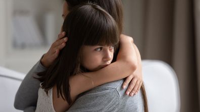 Child hugging adult