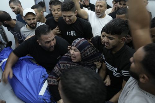 Relatives mourn Palestinian boy Ali Abu Khazna, who was killed during an Israeli army raid on Nur Shams refugee camp, in a morgue in Tulkarem, West Bank, Thursday, Oct. 19, 2023 
