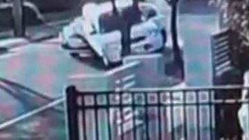 CCTV caught the dramatic moment an out-of control-car ploughed into a parked vehicle before slamming into a power pole.
