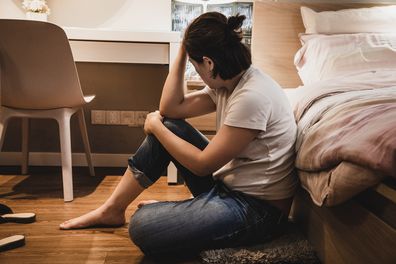 Sad woman sitting on bed