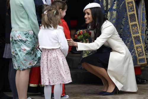 The royal bride-to-be chatted to a couple of youngsters outside. Picture: PA/AAP