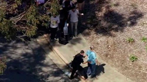 This image taken from video from KGO-TV shows a person is searched as police respond to reports of a shooting at YouTube headquarters in the city of San Bruno. (AP)