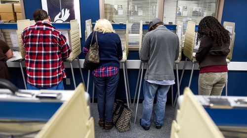 Voters filling out their ballots at the Citizens Service Centre in Colorado Springs. (AAP)