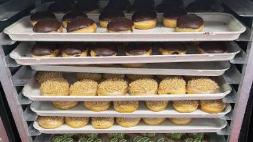 A delivery van packed with 10,000 fresh doughnuts was stolen when the driver left it to go inside a service station.