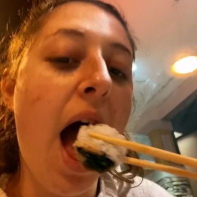 Woman overeats sushi at buffet