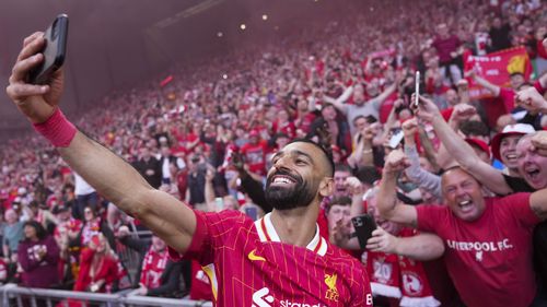 Liverpool's Mohamed Salah celebrates by taking a selfie after winning the English Premier League soccer match between Liverpool and Tottenham Hotspur and clinching the Premier League title at Anfield in Liverpool, England, Sunday, April 27, 2025. (AP Photo/Jon Super)