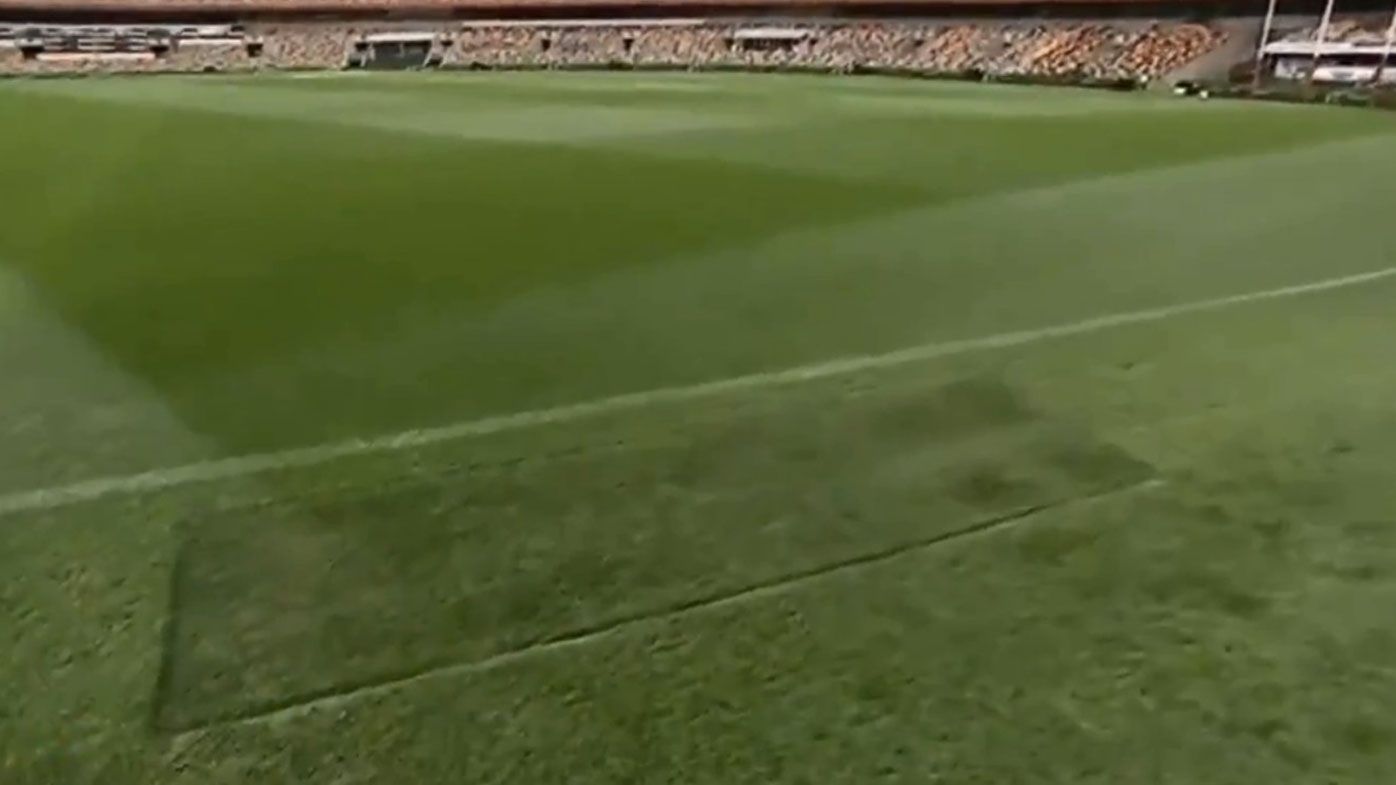 The patch of MCG goalsquare turf finds its new home at the Gabba.