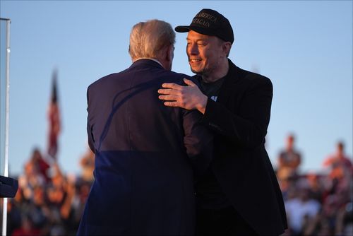 Republican presidential candidate former President Donald Trump hugs Elon Musk at a campaign rally at the Butler Farm Show, Saturday, Oct. 5, 2024, in Butler, Pa. 