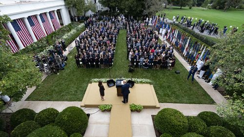 President Donald Trump (centre) stands with Judge Amy Coney Barrett on September 26, 2020, as they arrive for a news conference to announce Barrett as his nominee to the Supreme Court, in the Rose Garden at the White House in Washington.