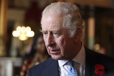 King Charles III talks with guests during a reception and ceremony commemorating the 50th anniversary of the Resettlement of British Asians from Uganda in the UK, at Buckingham Palace in London, Nov. 2, 2022 