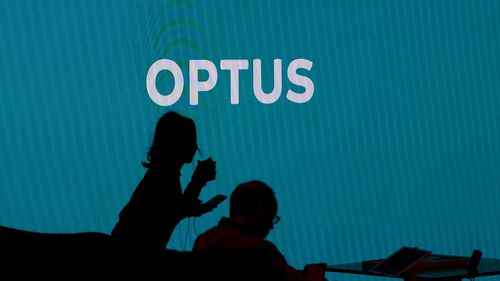 Customers wait to be served inside an Optus store