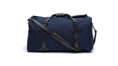 <a href="http://needsupply.com/mens/accessories/medium-duffle-bag-in-navy.html "> Medium duffle bag in navy, $345, Filson </a> 