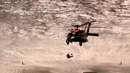 The three were pulled from the water and then winched onto a helicopter hovering above.