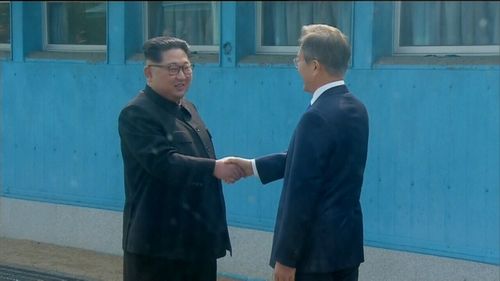 Kim said his heart was 'throbbing' as he shook Moon's hand.