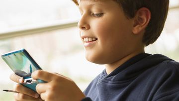 Boy plays a Nintendo DS console (Getty Images)