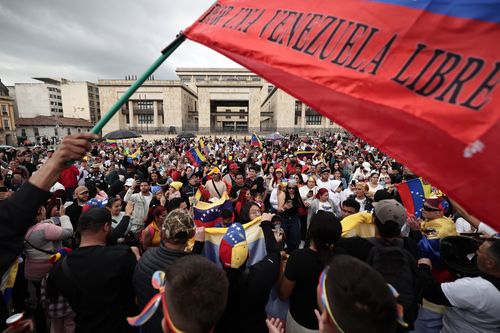 Venezuelans celebrate in BogotÃ¡, Colombia, Saturday, Jan. 3, 2026, after U.S. President Donald Trump announced that U.S. forces had captured Venezuelan President NicolÃ¡s Maduro. (AP Photo/Jose Vargas)