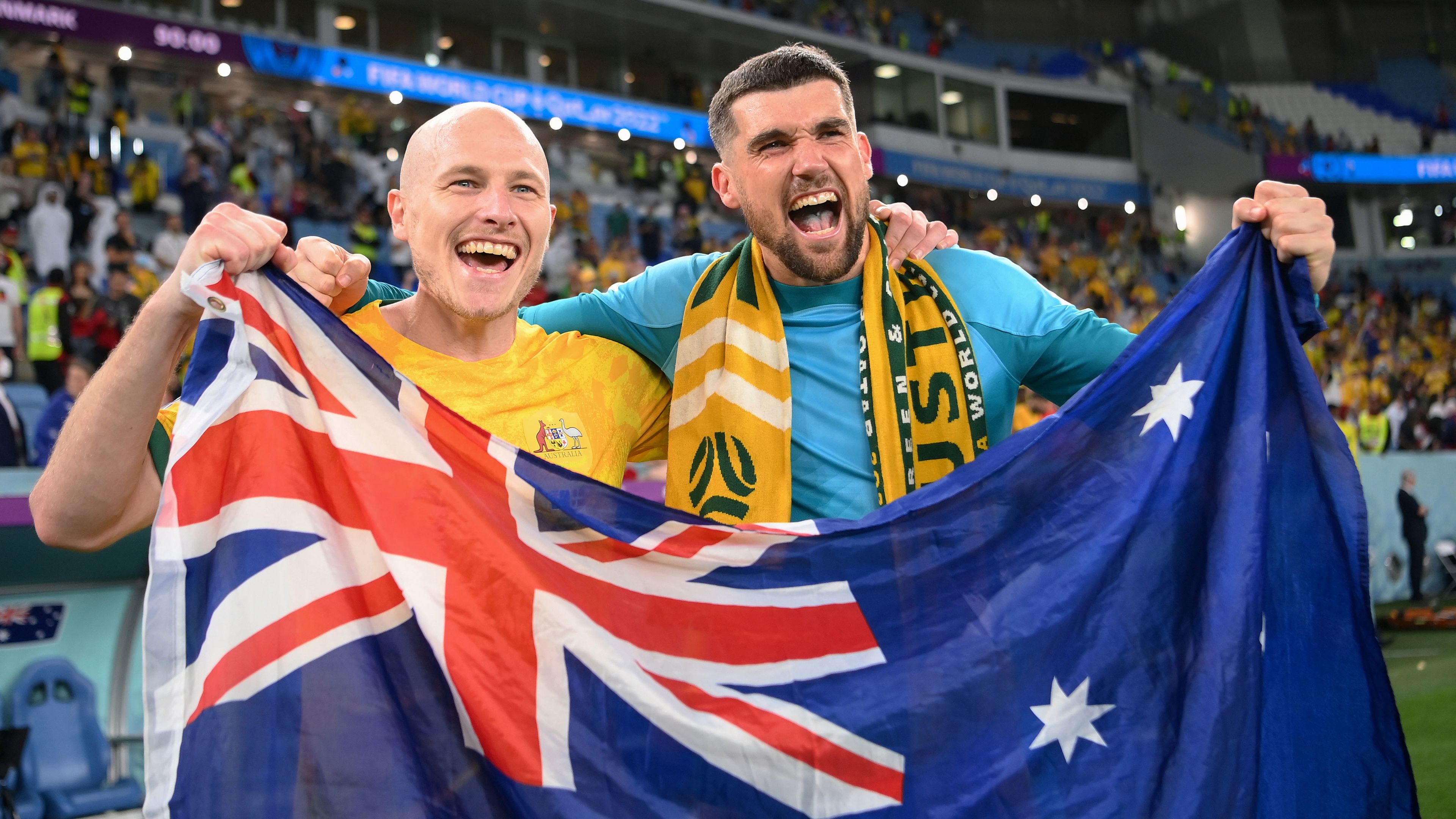 Aaron Mooy and Mathew Ryan celebrate their FIFA World Cup win over Denmark that qualified Australia for the last 16.