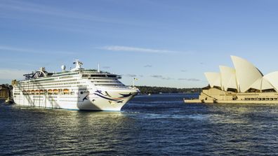Sydney Australia - August 4, 2017: A bright Winter's afternoon in Sydney, and the P&O cruise ship Pacific Explorer slowly backs out of Circular and prepares to steam past the Sydney Opera House.