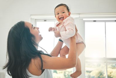 Mum holding happy baby