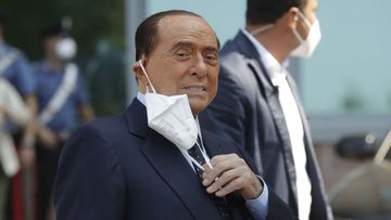 Italian former Premier Silvio Berlusconi adjusts his face mask as he leaves the San Raffaele hospital after testing positive for COVID-19, in Milan, Italy Monday, Sept. 14, 2020