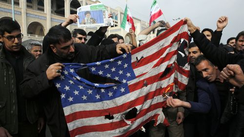 Iranians burn a US flag during an anti-US demonstration to condemn the killing of Iranian Revolutionary Guards Corps (IRGC) Lieutenant general and commander of the Quds Force Qasem Soleimani, after Friday prayers in Tehran, Iran