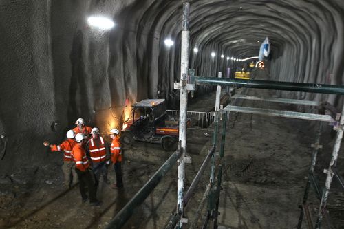 Construction workers in the new stretch of tunnel between Concord and Haberfield, as part of the WestConnex project in Sydney. (AAP)