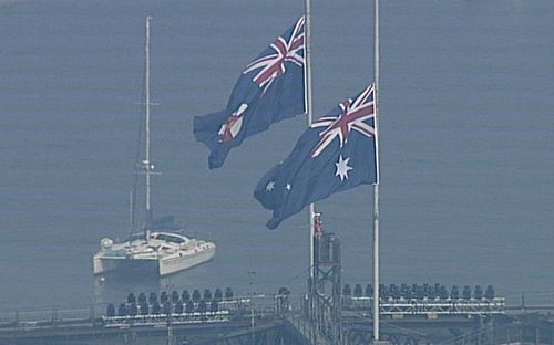 Flags on Sydney Harbour Bridge fly at half-mast, in honour of dead firefighter Sam McPaul.