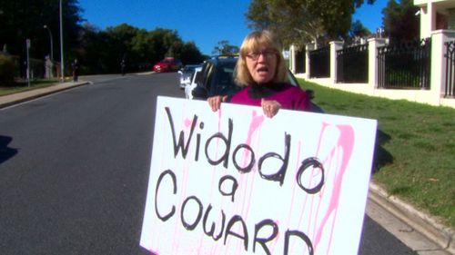 A woman has staged a solo protest outside the Indonesian embassy in Canberra. (9NEWS)
