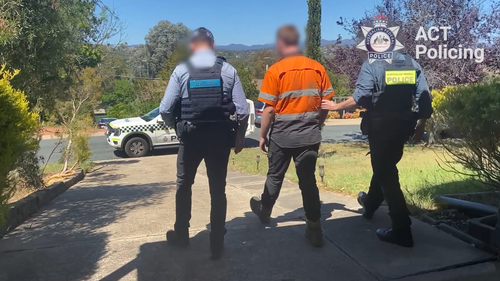 The man allegedly performed two separate Nazi salutes directed towards individuals at suburban Canberra shopping centres.