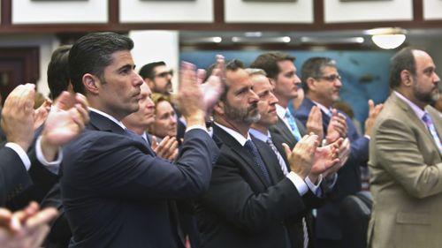 Florida House sponsor Rep. Jose Oliva (second from left) is joined by other House members in applause after a school safety bill passed the House on Wednesday. (AAP)