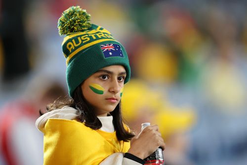 A young Matildas supporter welcomes her team to the field.