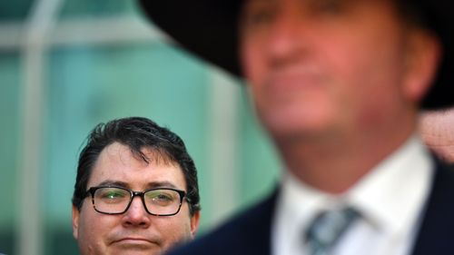 Nationals MP George Christensen looks on at the former Deputy Prime Minister in June. (AAP)