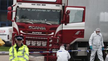 Forensic police officers attend the scene after a truck was found to contain a large number of dead bodies, in Grays, England, October 23, 2019.  