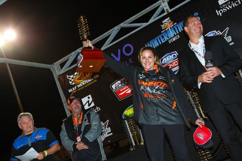 Kelly Bettes holds aloft the trophy after beating off the male competition to win the Top Fuel drag racing championship. Picture: Drag Photos
