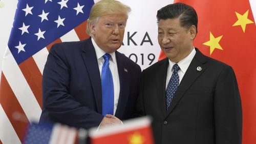  In this June 29, 2019, file photo, U.S. President Donald Trump poses for a photo with Chinese President Xi Jinping during a meeting on the sidelines of the G-20 summit in Osaka, Japan. The Trump administration and China are expected to announce a modest trade agreement by Friday, Dec. 13, 2019 that would suspend tariffs set to kick in Sunday, deescalating their 17-month trade war.