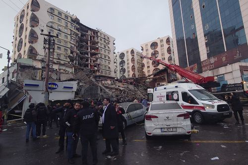 Rescue workers and medical teams try to reach trapped residents in a collapsed building following and earthquake in Diyarbakir, southeastern Turkey, early Monday, Feb. 6, 2023.
