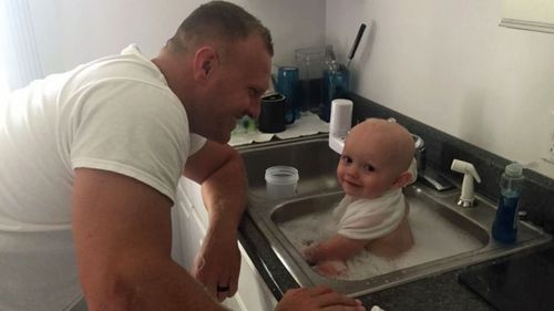 Police officer bonds with neglected baby during warm bath