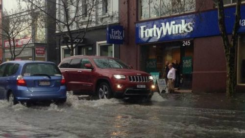 Flash flooding slows traffic in Burwood Rd, Hawthorn. (9NEWS)
